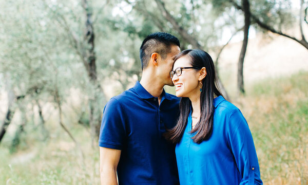 a man standing close to a woman